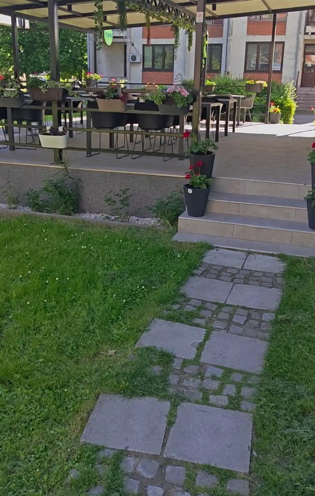 Stone pathway leading to the garden of Aloo Aloo Pizzeria in the center of Sremska Mitrovica